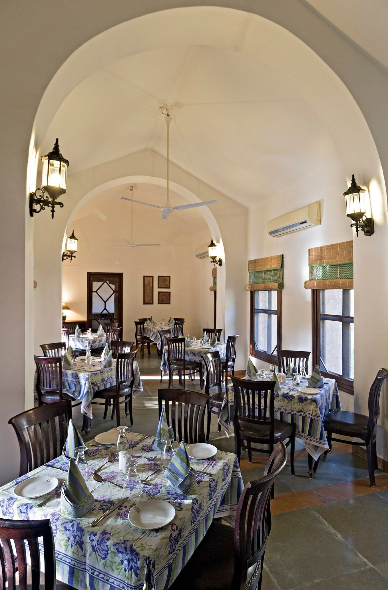An image of the seating arrangement at with minimal decoration Taasli Restaurant of Manvar Shergarh - Manvar Resort & Desert Camp
