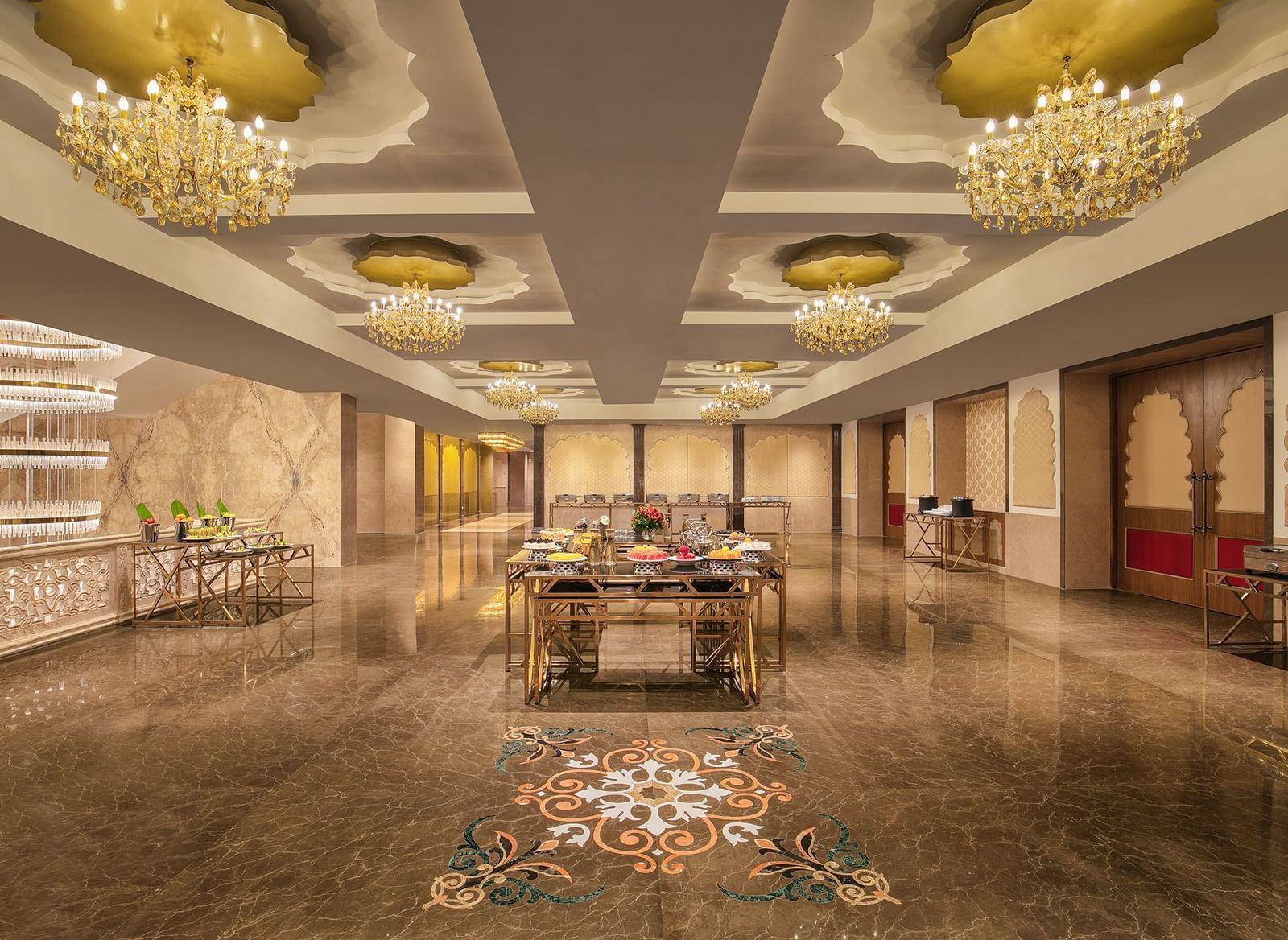A banquet area with a long table, elegant decor, and chandeliers – Kaldan Samudra Palace, a stunning Luxury Marriage Hall ECR