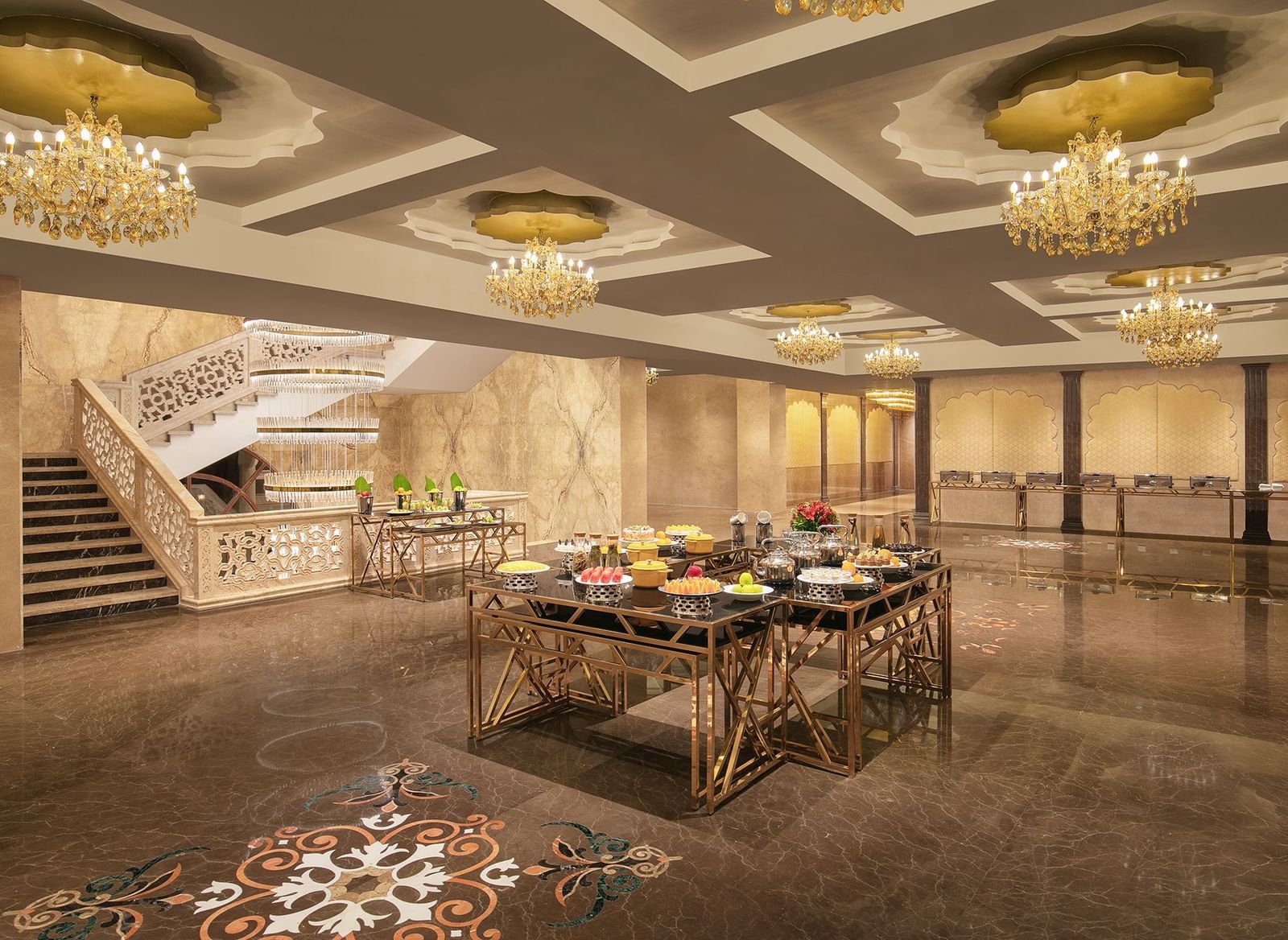 A banquet area with a table filled with foods placed under chandeliers – Kaldan Samudra Palace, one of the Best Banquet Halls in ECR