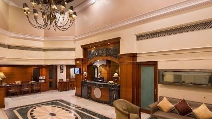 A luxurious hotel suite living area is elegantly furnished with comfortable seating - Lords Inn Vadodara