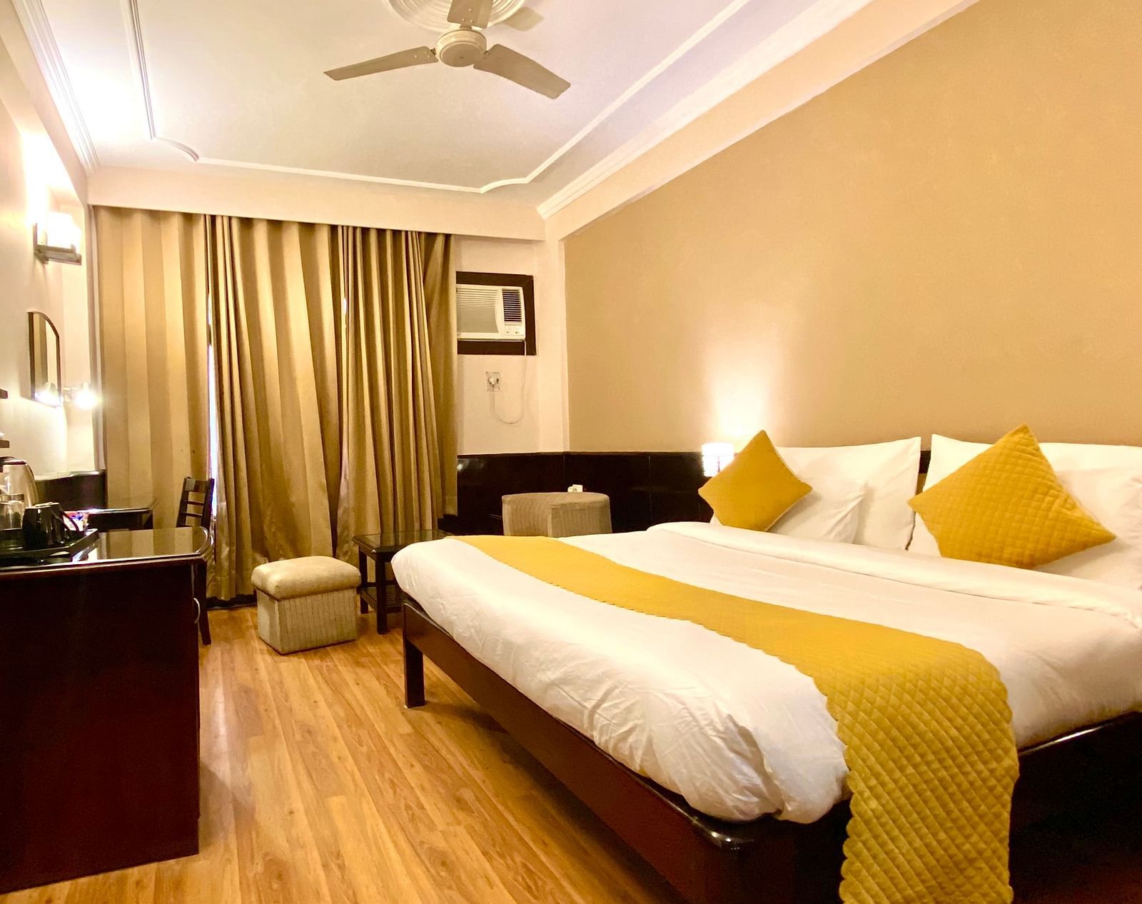Side view of deluxe room with a wall-mounted television at DLS Park Grace, Haridwar.