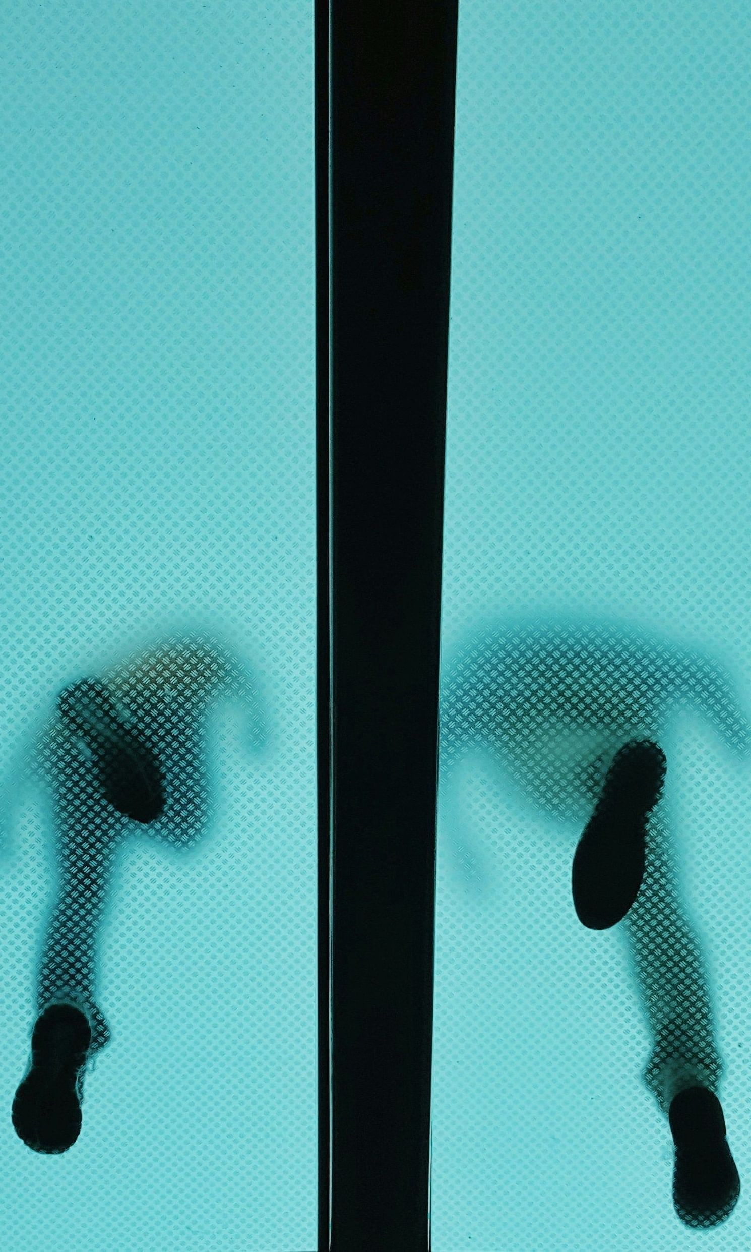 A lower angle shot two men waling over the skywalk.
