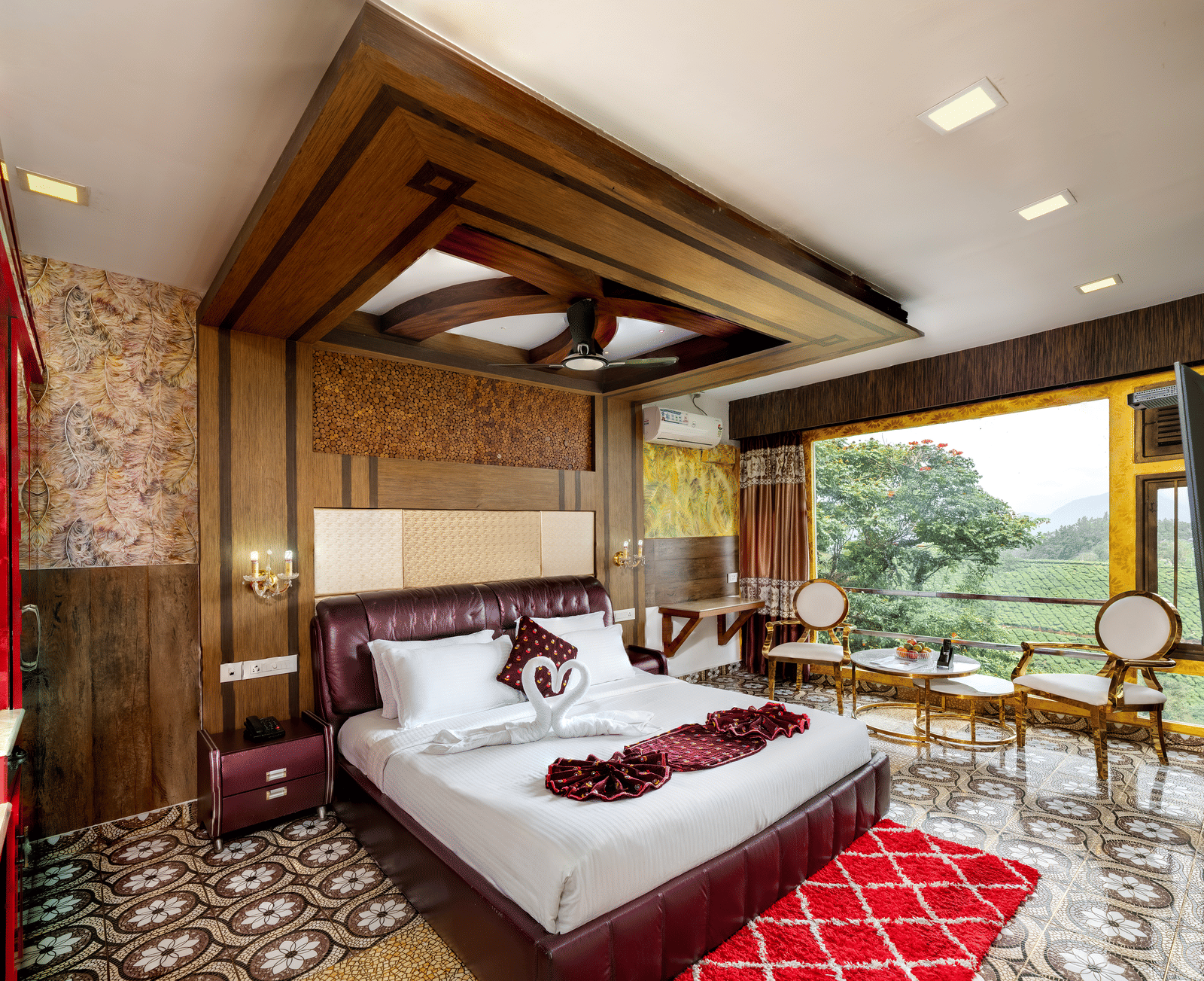 A sleeping area in the Double Bedroom Pool Villa at Parakkat Nature Hotel and Resorts, Munnar, featuring decorative wood ceiling work, a large bed, and expansive windows overlooking the landscape.
