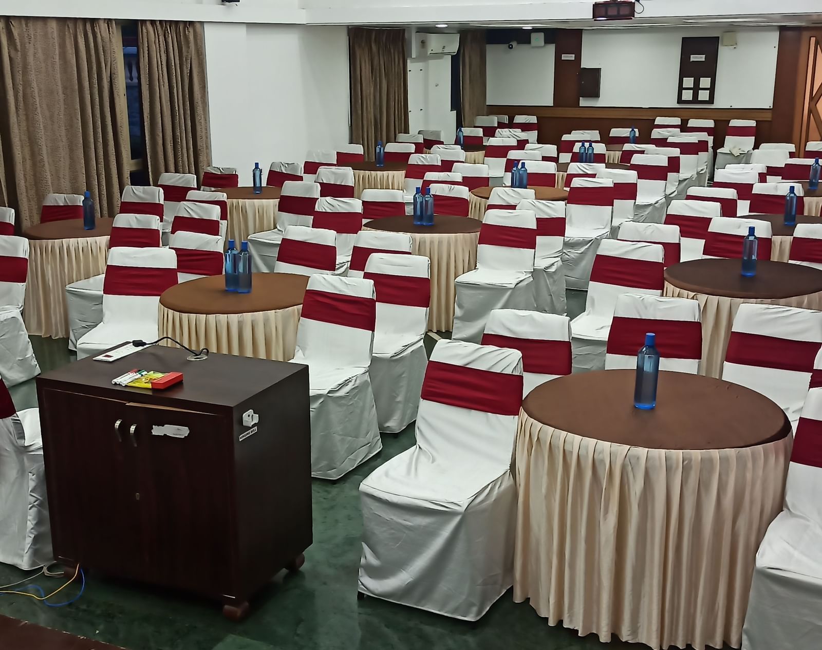Cluster seating arrangement at Mayur Retreat with ceiling-to-floor windows on either sides.