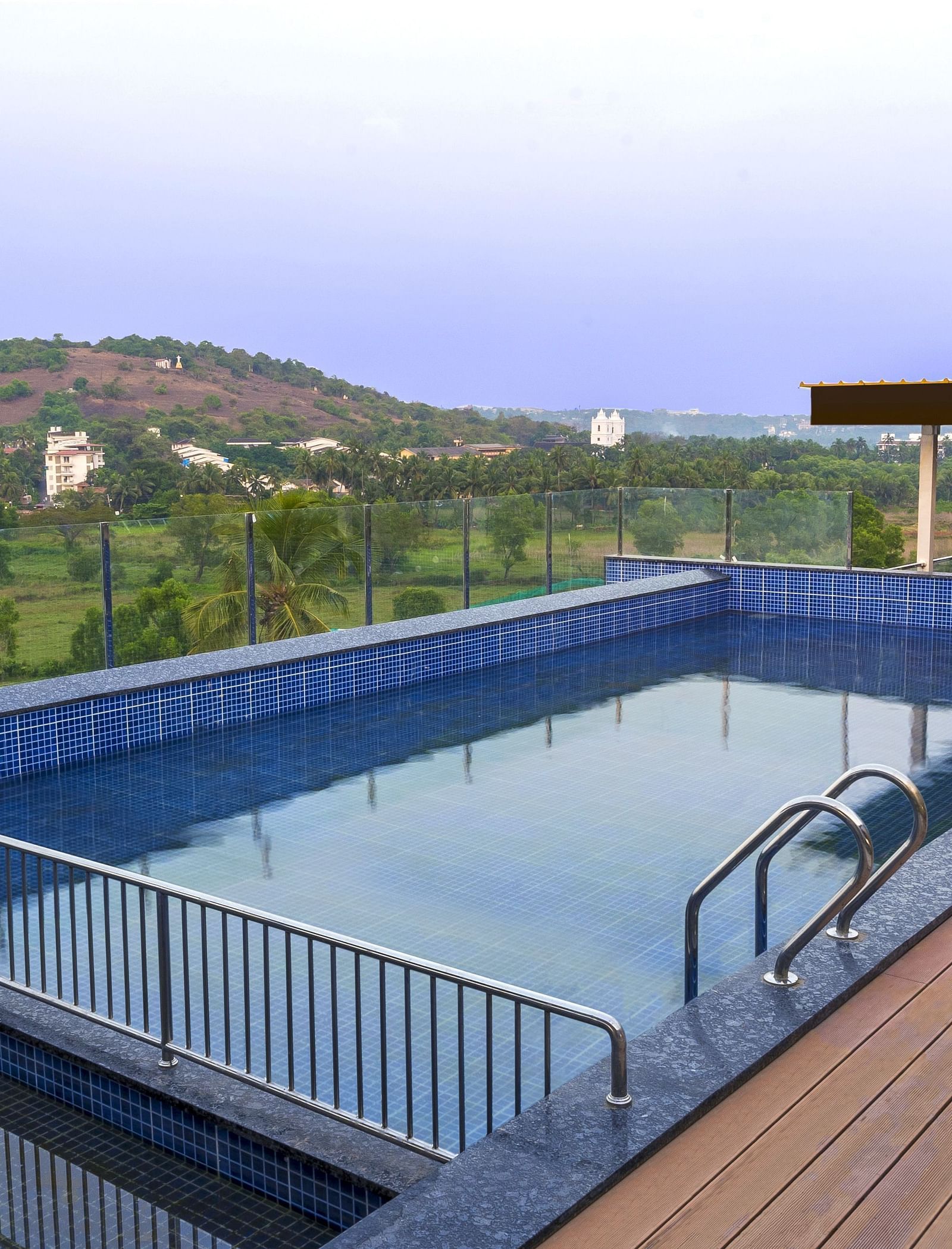 Overview of the swimming pool with a walking deck next to it - The Tanisi Hotels & Resorts, Goa