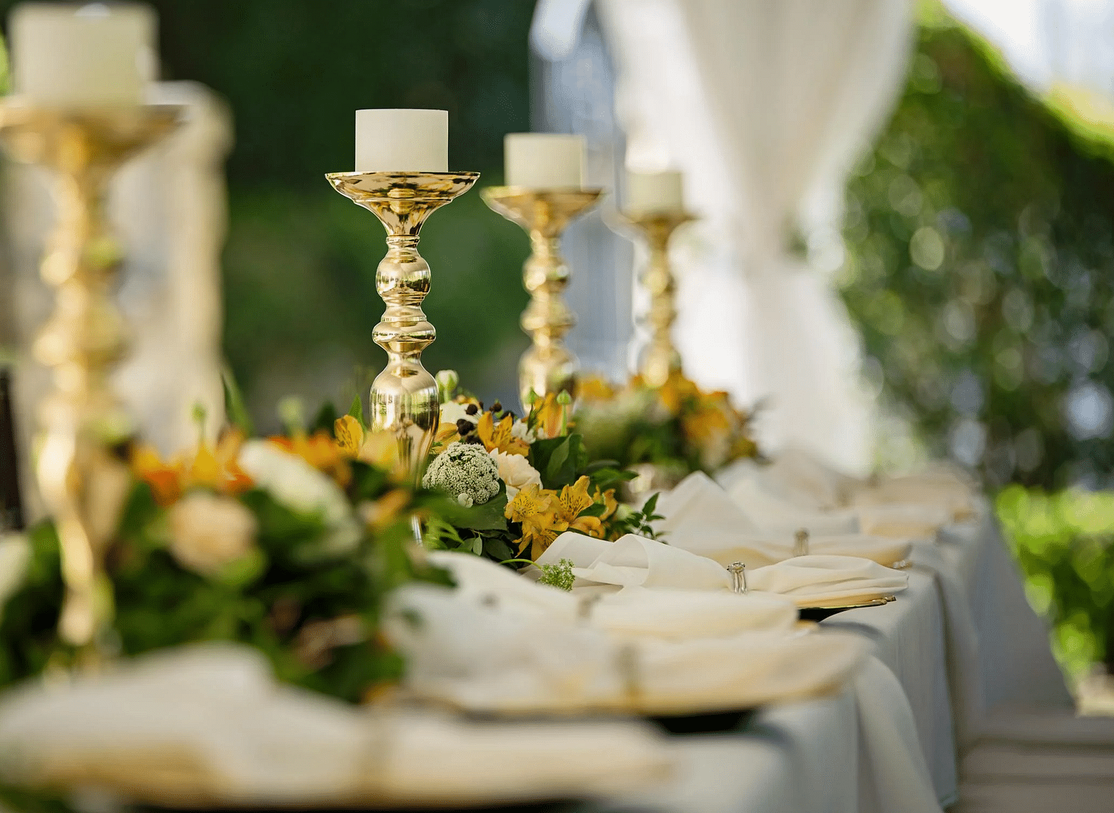 Image of a table with candles and cutlery placed on it.