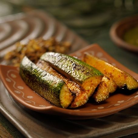 Roasted zucchini spears with a side of chutney.