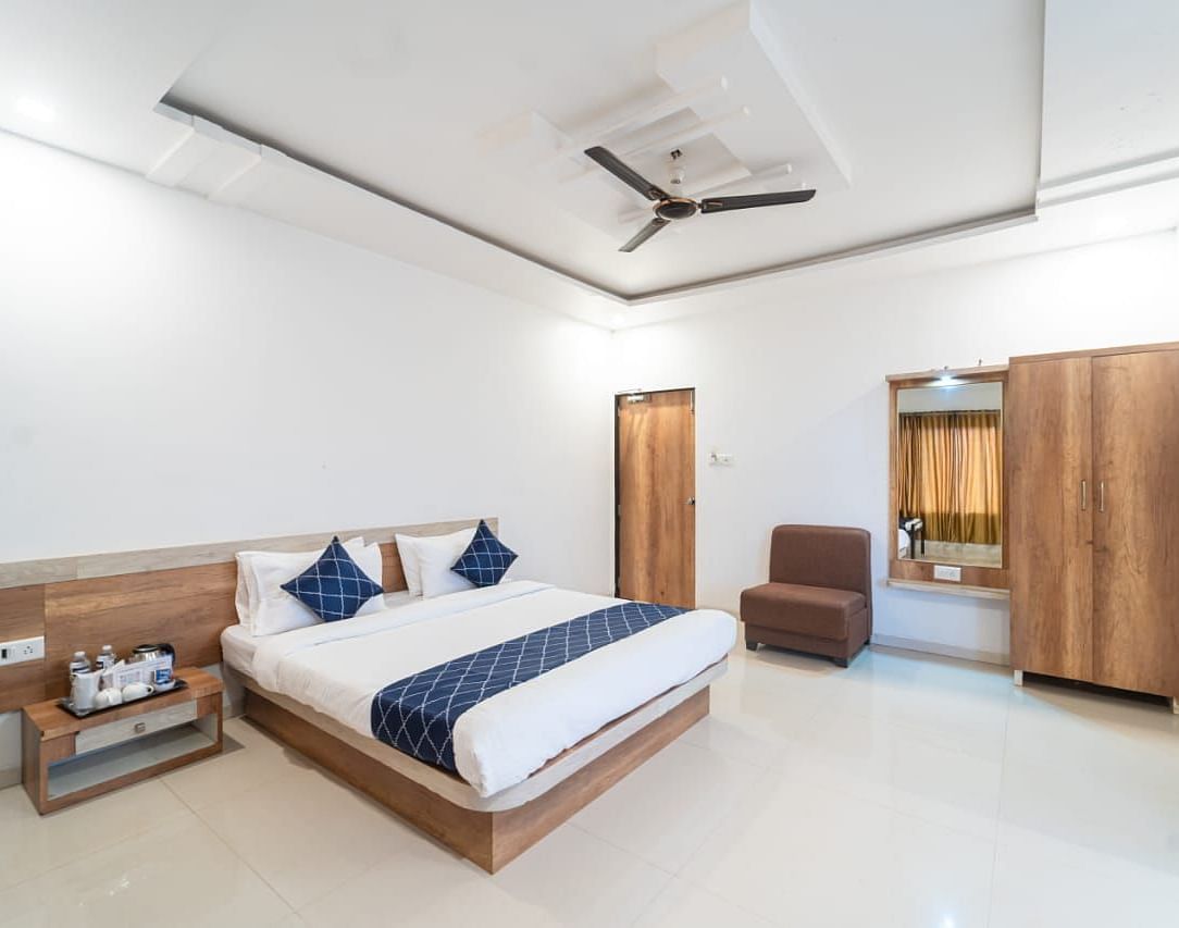 Penthouse Suite with Balcony with a king size bed, a nightstand, a chair, and a wardrobe.