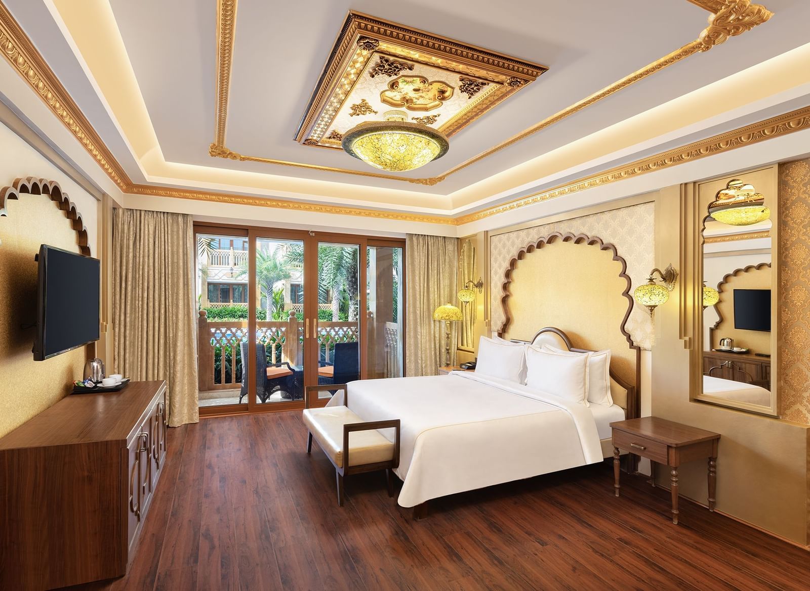 An elegant bedroom with a canopy-styled headboard and artistic wall panelling – Kaldan Samudra, one of the finest Mahabalipuram resorts with private beach