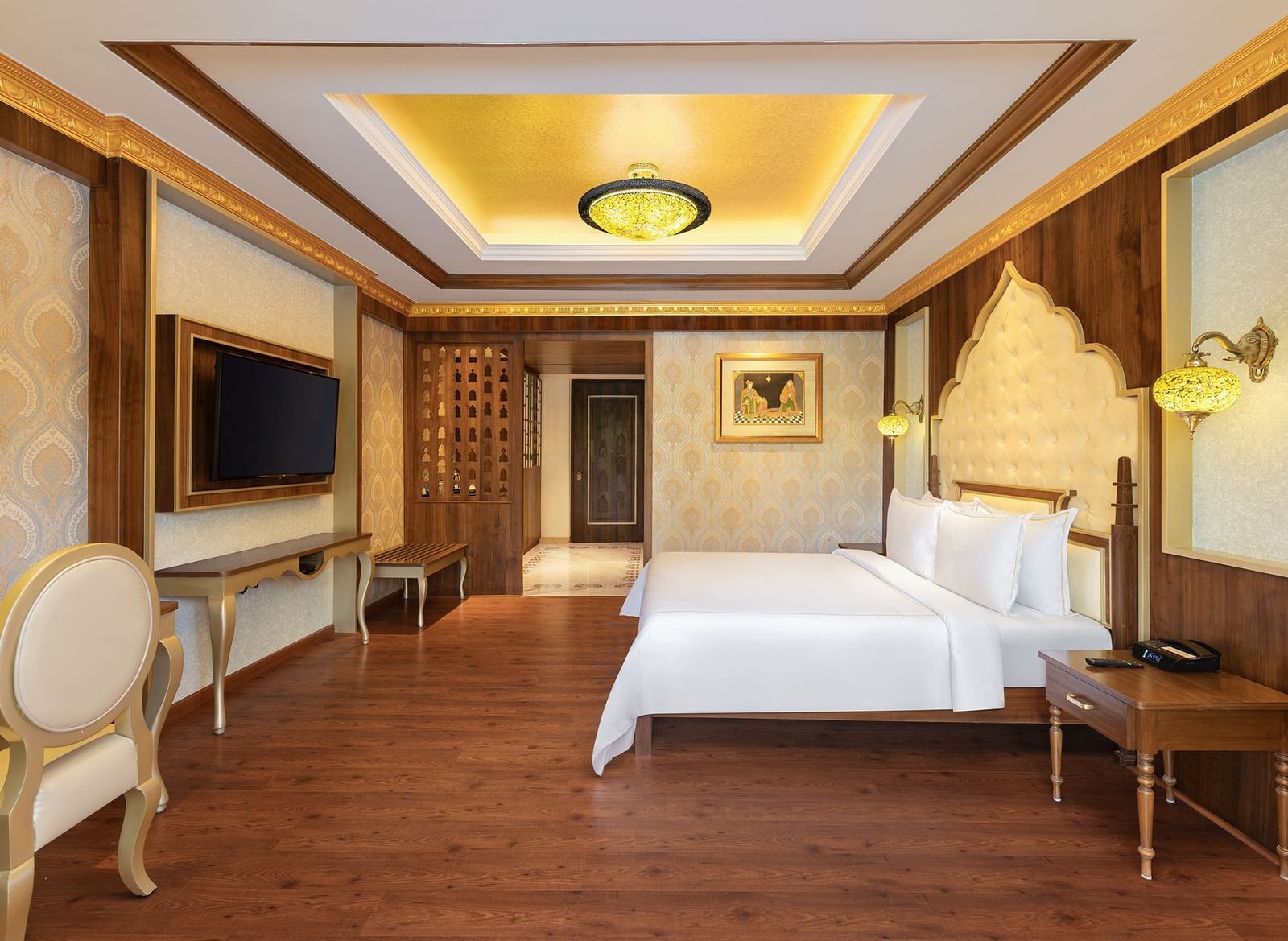 A hotel room in Mahabalipuram with rich wooden flooring, a large bed, and comfortable seating arrangement – Kaldan Samudra, one of the top beach resorts in ECR