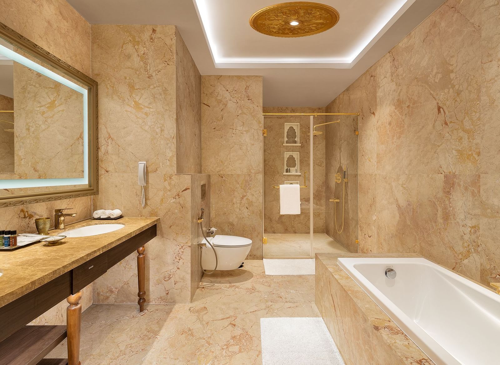 A lavish marble bathroom with a modern bathtub and double sink vanity counter - Kaldan Samudhra