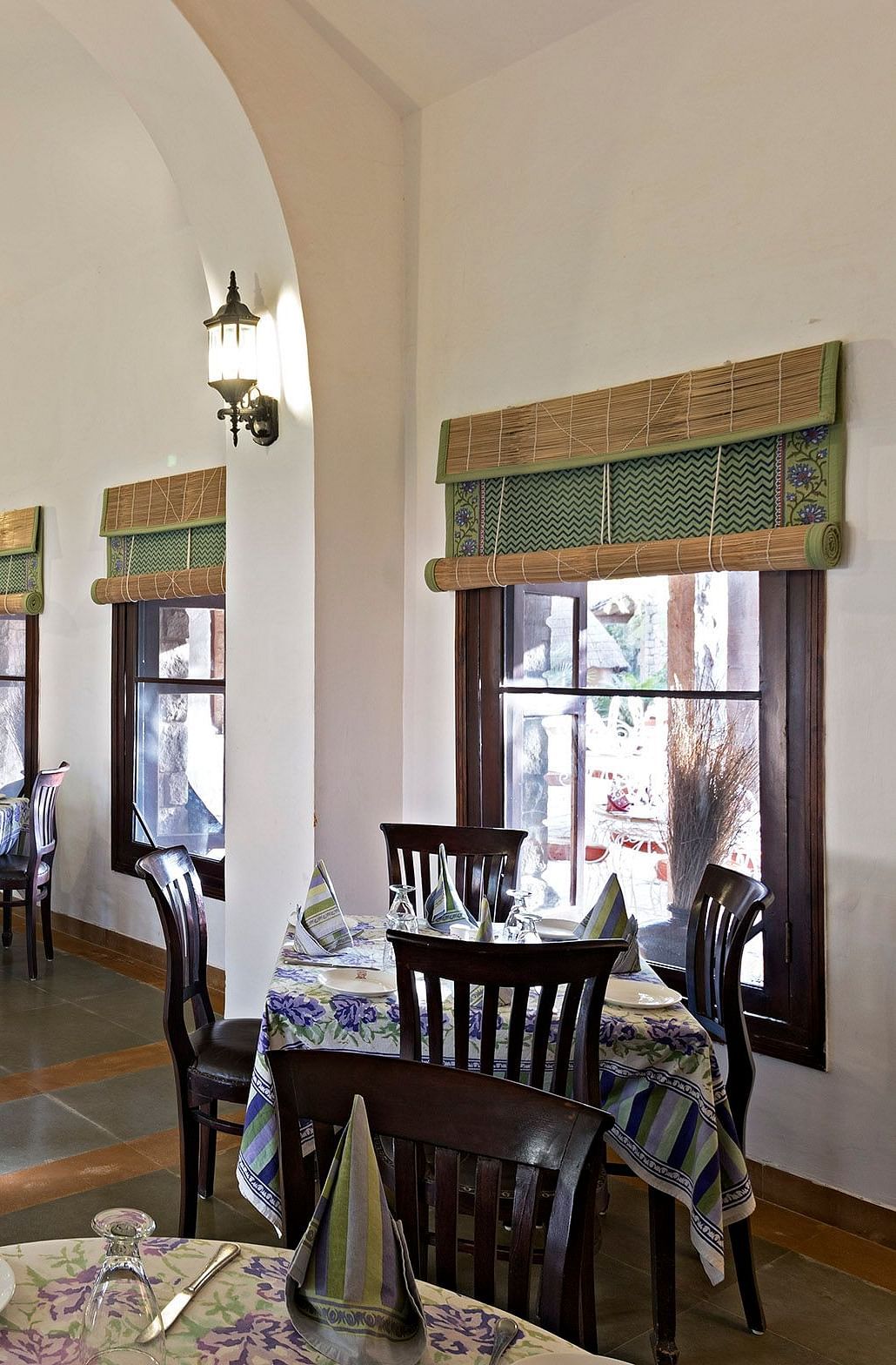 An image of the seating arrangement at with minimal decoration Taasli Restaurant of Manvar Shergarh - Manvar Resort & Desert Camp