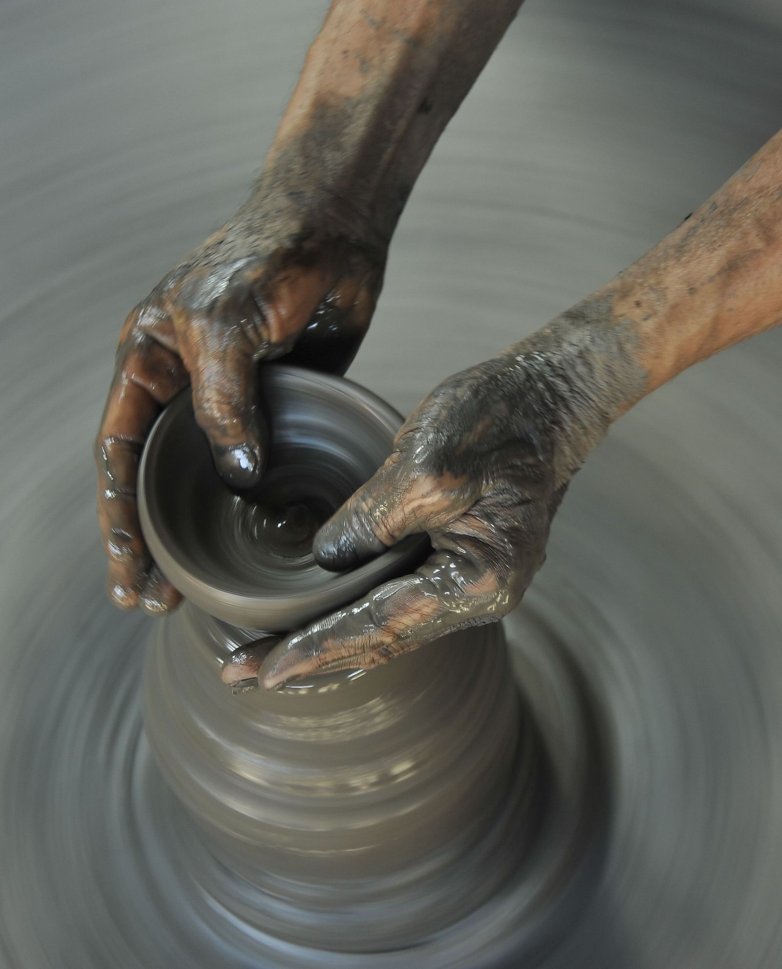 A pair of hands doing pottery