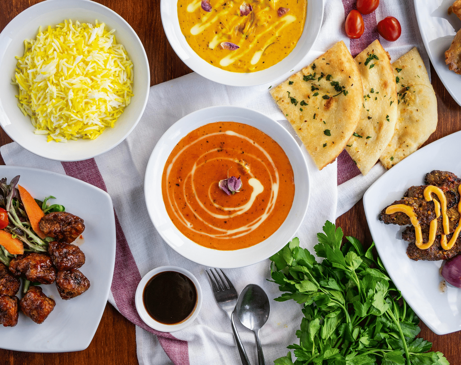 A top shot of a delicious spread of various Indian dishes served on a table.