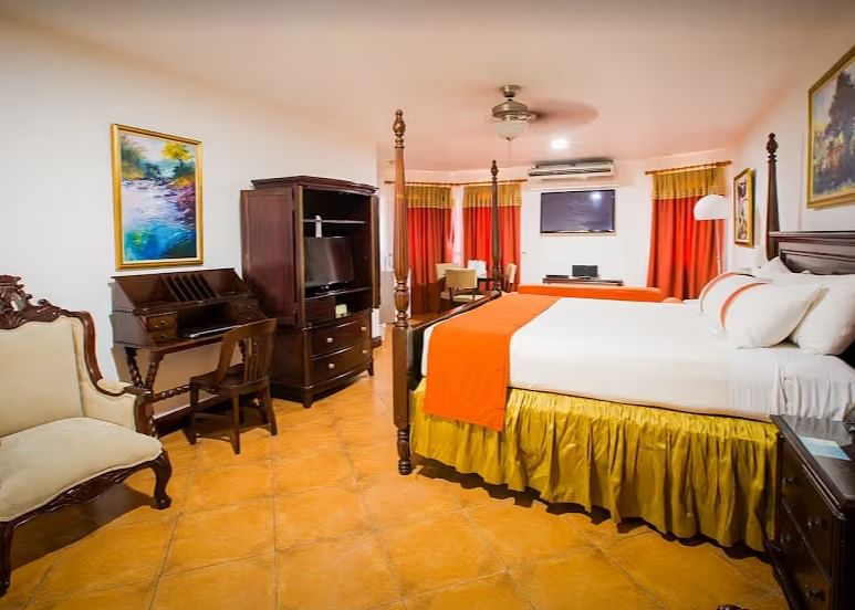 tiled bathroom shows a bathtub, a vanity with two sinks, and a walk-in shower | Alexander Suite | Altamont Court, Jamaica