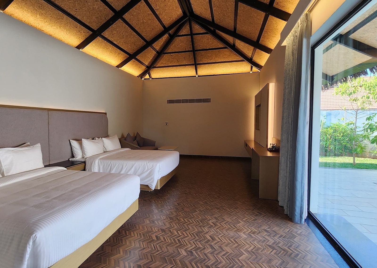Corner view shot of the Exotic Pool Villa with the roof lined with yellow lighting at The Shore, Trishvam.