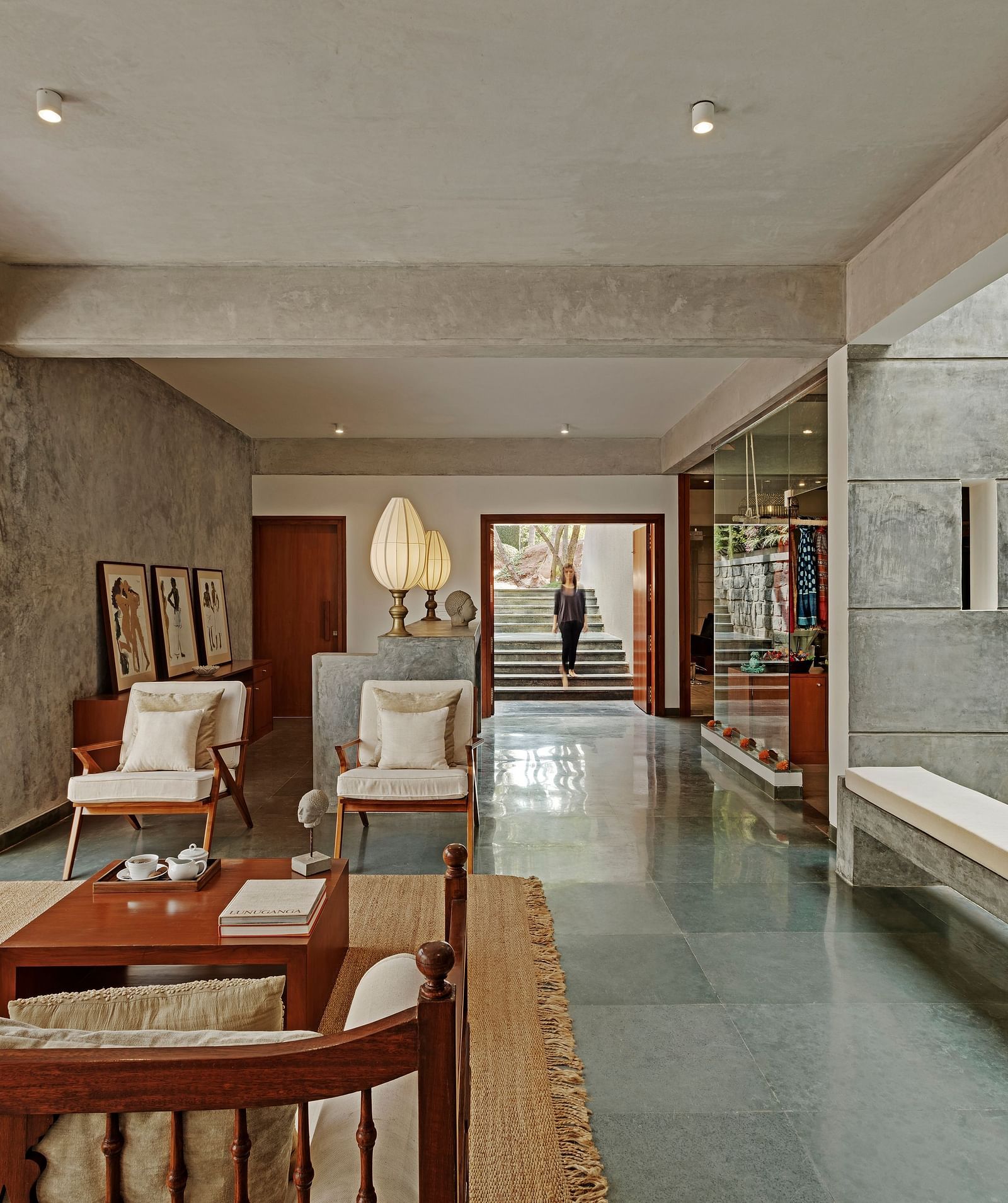 Long hallway with seating and a view of a garden, indoor setting - Shreyas Retreat