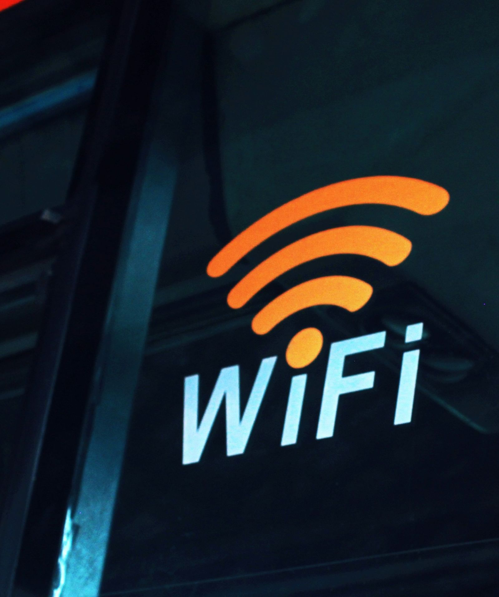 A glowing Wi-Fi symbol with the word 'WiFi' beneath it, displayed on a dark background.